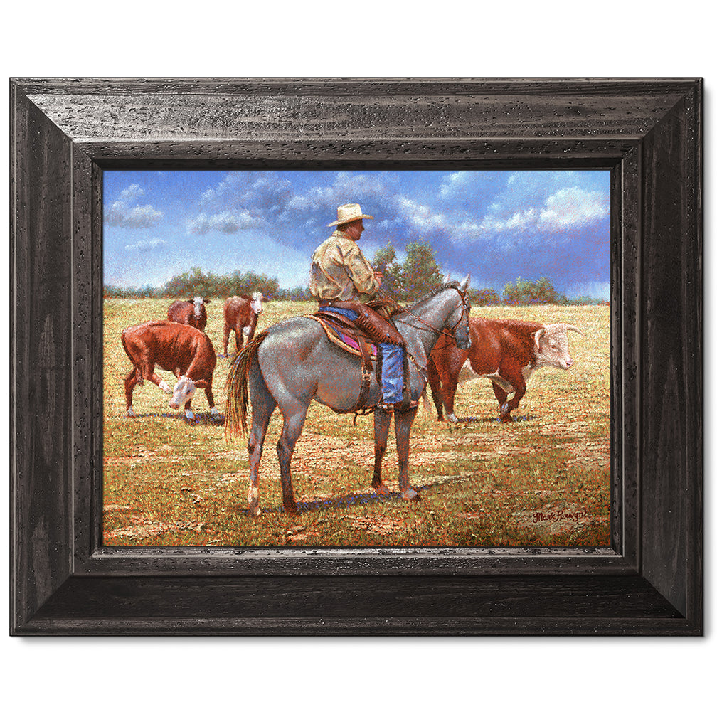 canvas print in a black wood frame depicting a cowboy on
horseback herding herefords with rain showers in the distance