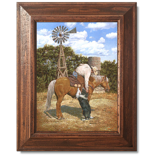 canvas print in a brown wood frame depicting a cowboy on
horseback leaning over petting his border collie