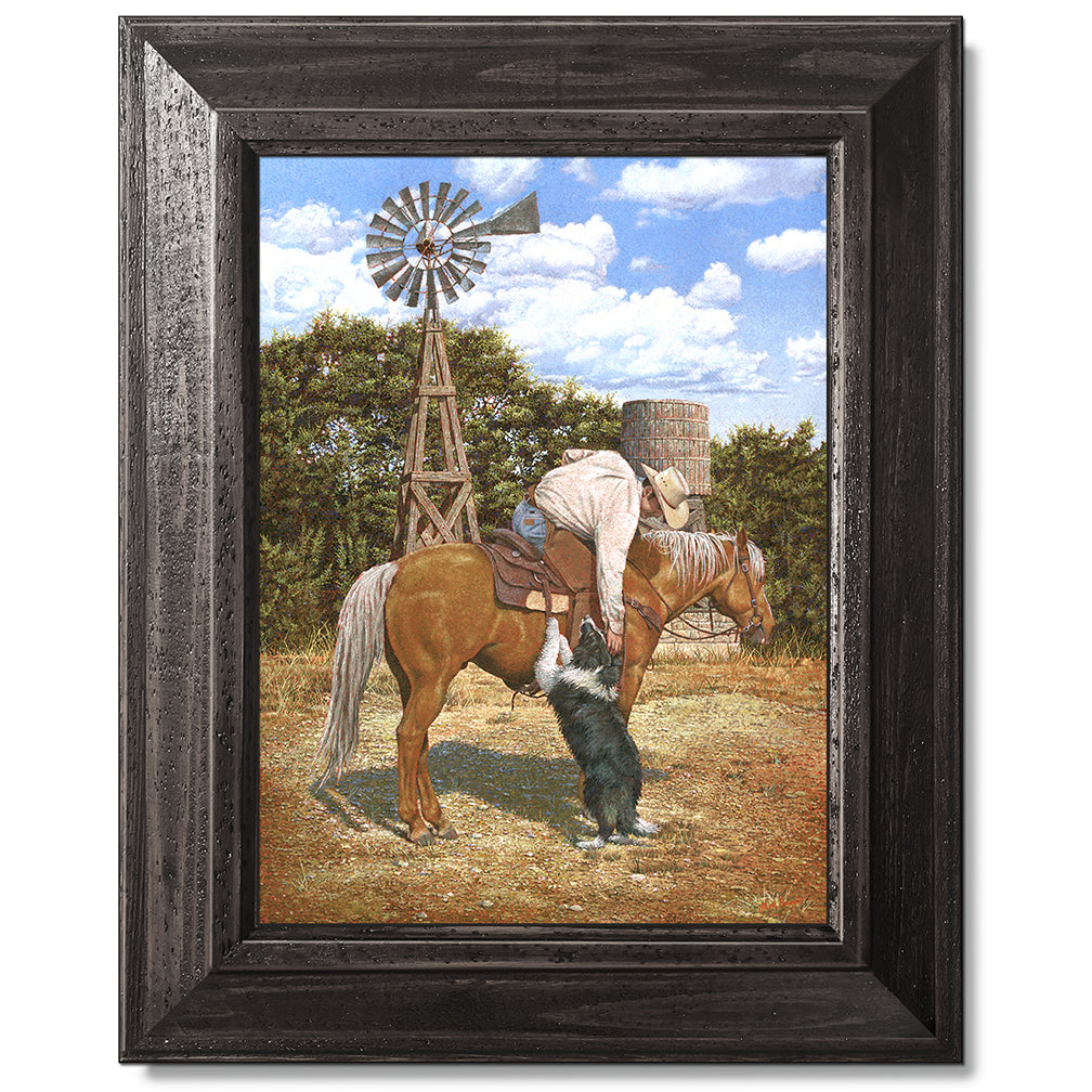 canvas print in a black wood frame depicting a cowboy on
horseback leaning over petting his border collie