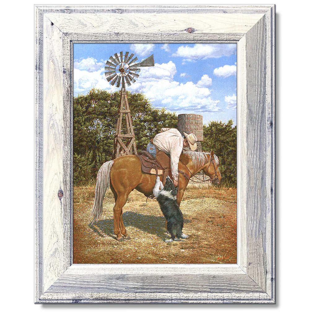 canvas print in a white wood frame depicting a cowboy on
horseback leaning over petting his border collie