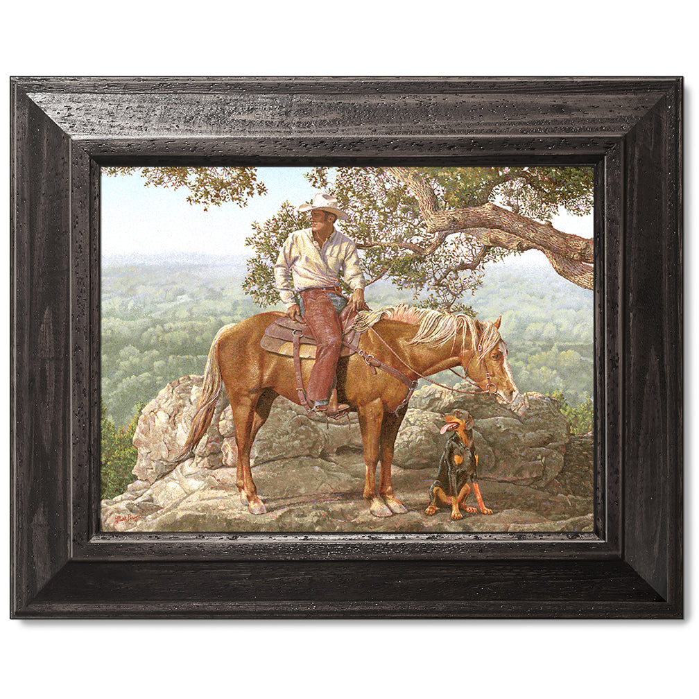 canvas print in a black wood frame depicting a cowboy on
horseback with his dog alongside