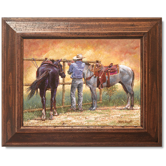 canvas print in a brown wood frame depicting a cowboy standing
between two horses while a dust devil dances around them