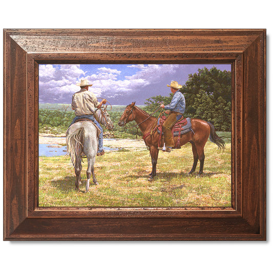 canvas print in a brown wood frame depicting a country landscape
with two cowboys on horseback watching a thunderstorm