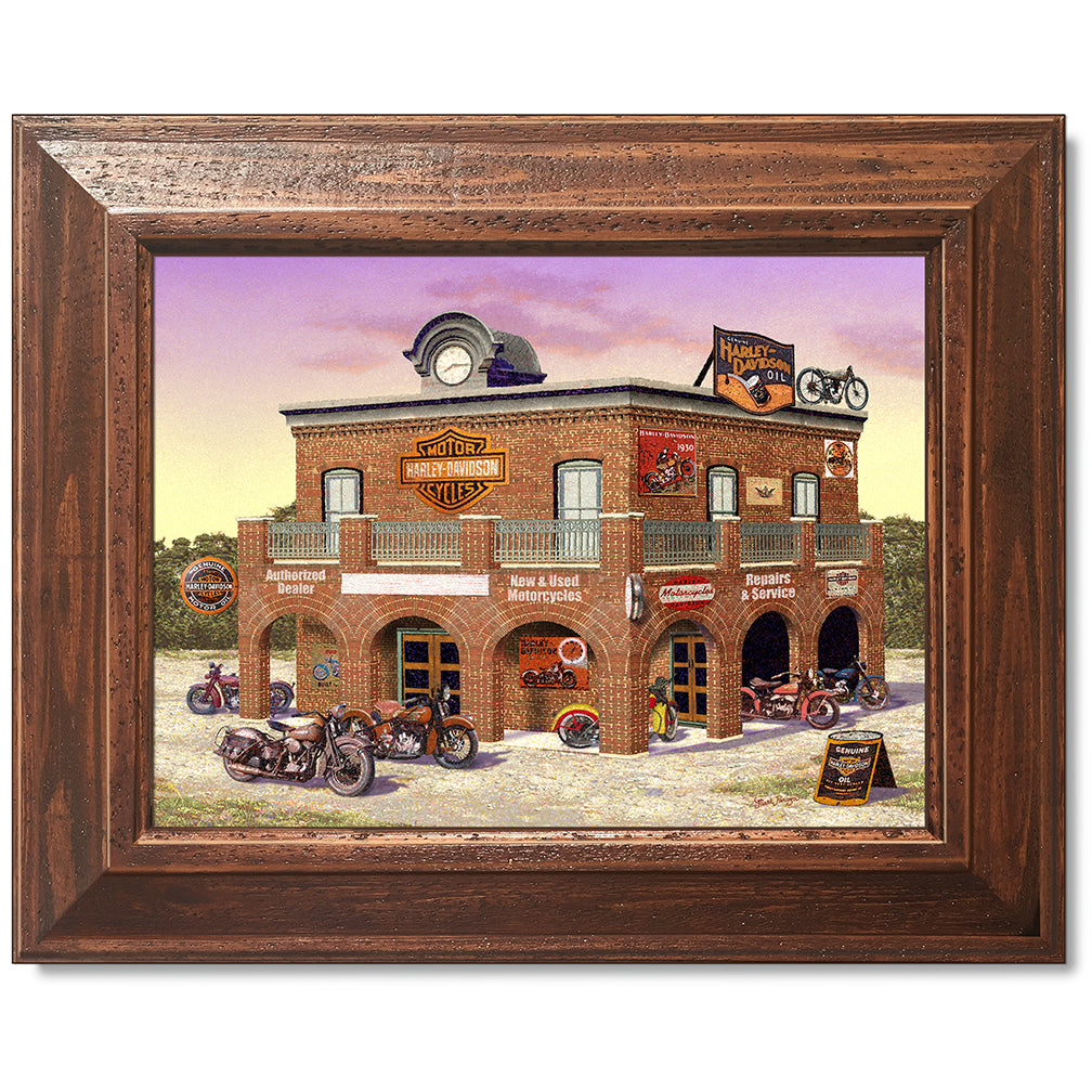 canvas print in a brown wood frame depicting classic motorcycles
parked in front of a vintage harley-davidson dealership