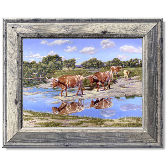 canvas print in a grey wood frame depicting four longhorns
crossing the llano river within a country landscape