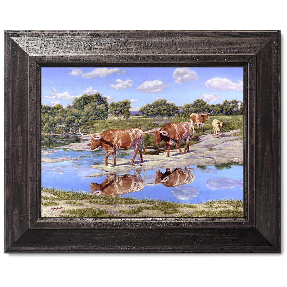 canvas print in a black wood frame depicting four longhorns
crossing the llano river within a country landscape