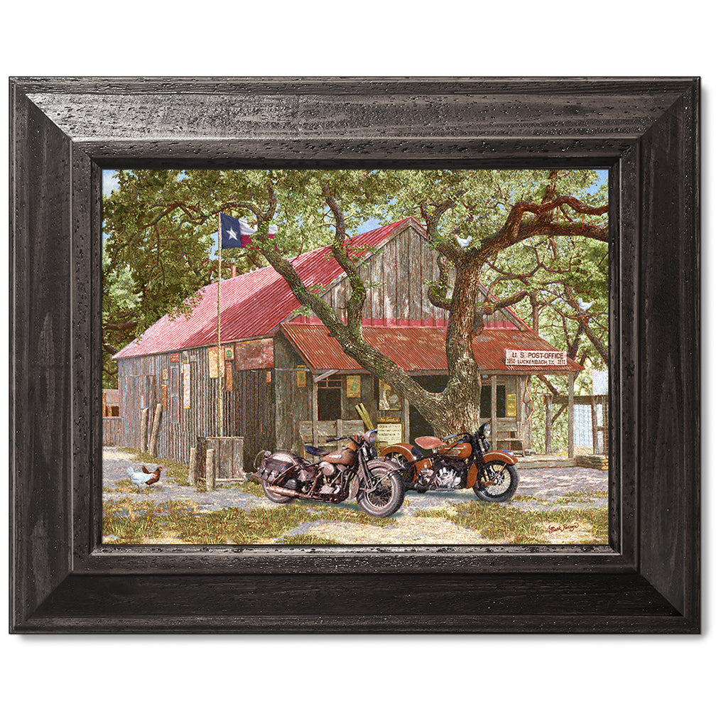 canvas print in a black wood frame depicting classic motorcycles
parked in front of the luckenbach, texas post office