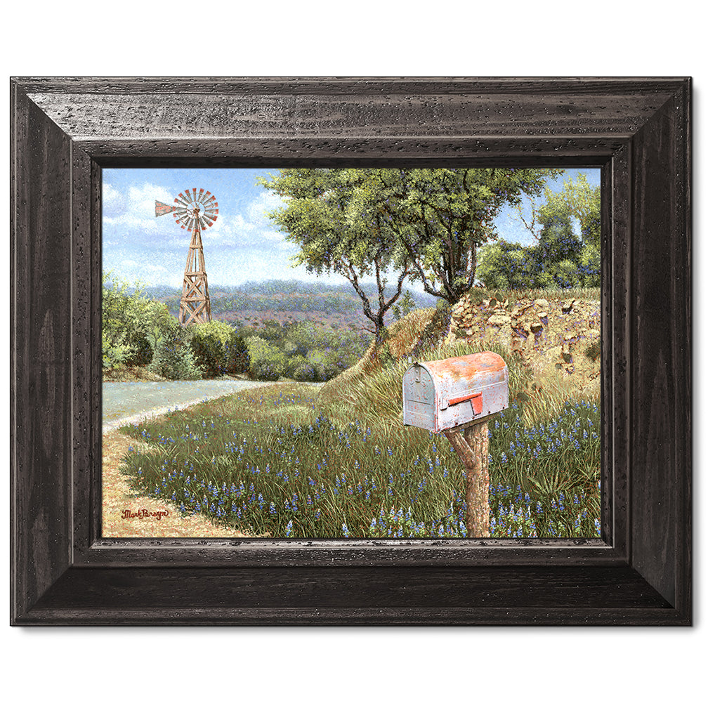 canvas print in a black wood frame depicting a mailbox along a
country road with a windmill in the background