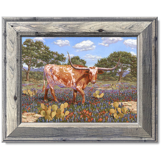 canvas print in a grey wood frame depicting a longhorn standing
in a country landscape with a texas shape on his side