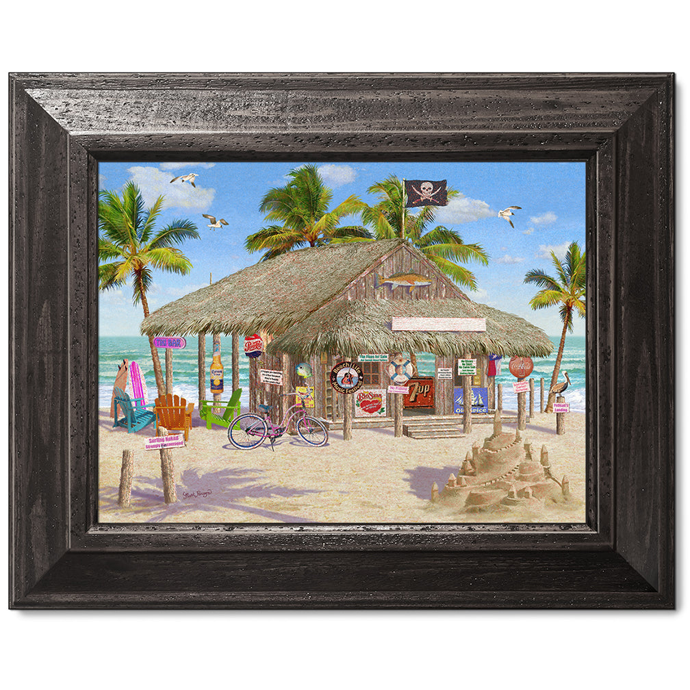 canvas print in a black wood frame depicting a tiki bar on a beach
with a sandcastle, waves and palm trees
