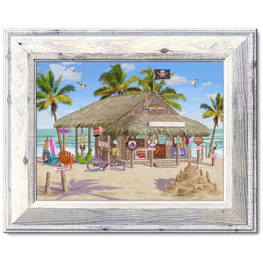 canvas print in a white wood frame depicting a tiki bar on a beach
with a sandcastle, waves and palm trees