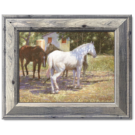canvas print in a grey wood frame depicting a white horse
standing under a tree for shade in a rustic landscape