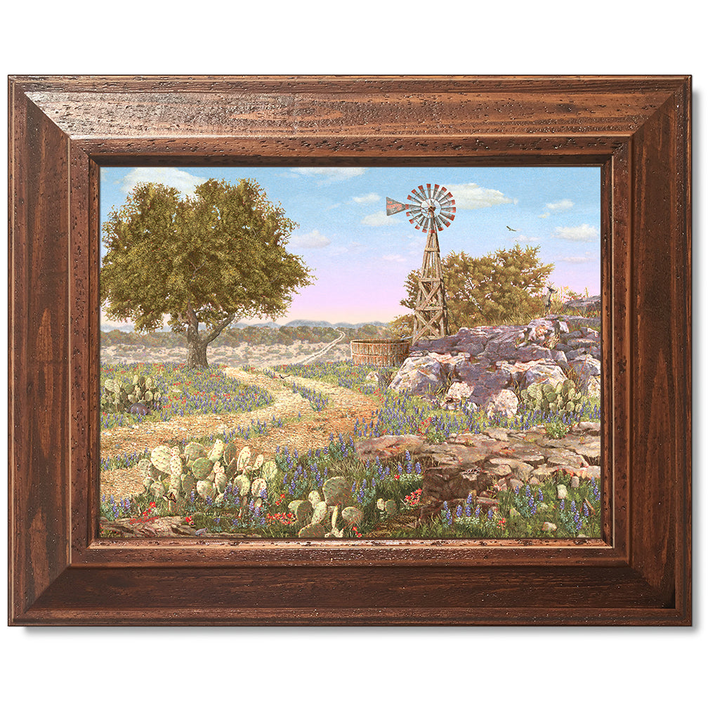 canvas print in a brown wood frame depicting a hill country landscape
with wildflowers, cactus, windmill and eleven hidden animals