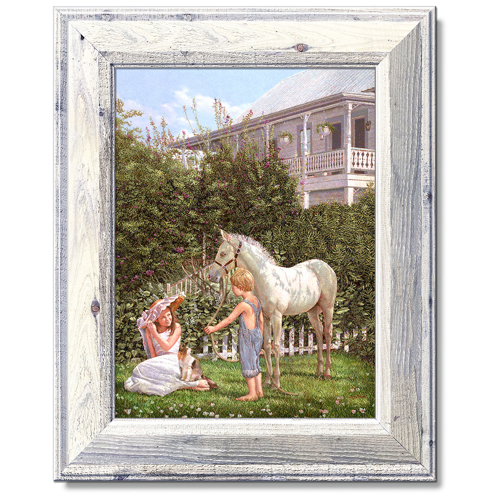 canvas print in a white wood frame depicting children and a pony
with floral vegetation and a victorian house in the background