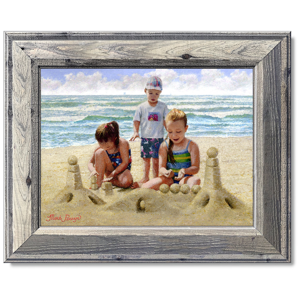 canvas print in a grey wood frame depicting children building
a sandcastle on a beach with waves in the background