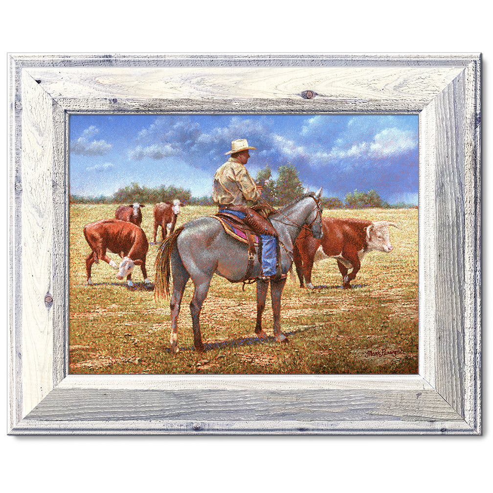 canvas print in a white wood frame depicting a cowboy on 
horseback herding herefords with rain showers in the distance 