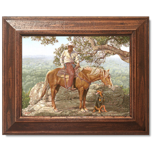 canvas print in a brown wood frame depicting a cowboy on
horseback with his dog alongside