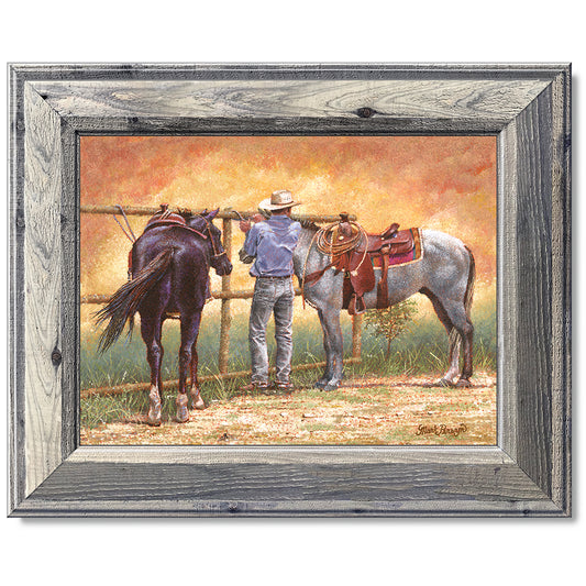 canvas print in a grey wood frame depicting a cowboy standing
between two horses while a dust devil dances around them