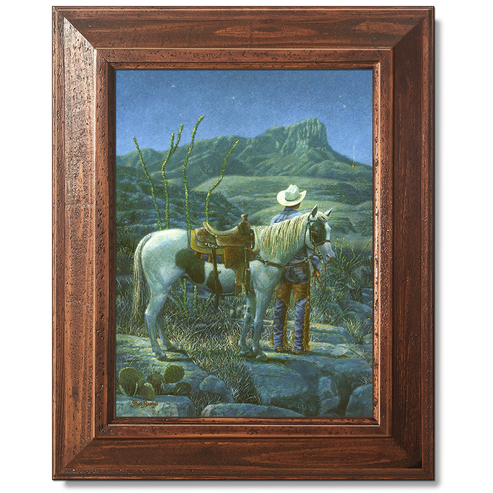 canvas print in a brown wood frame depicting a cowboy next to his
horse looking at a signal fire below guadalupe peak