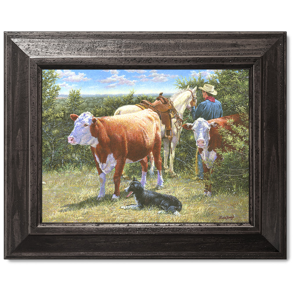 canvas print in a black wood frame depicting a cowboy with his
horse, herefords, and his border collie