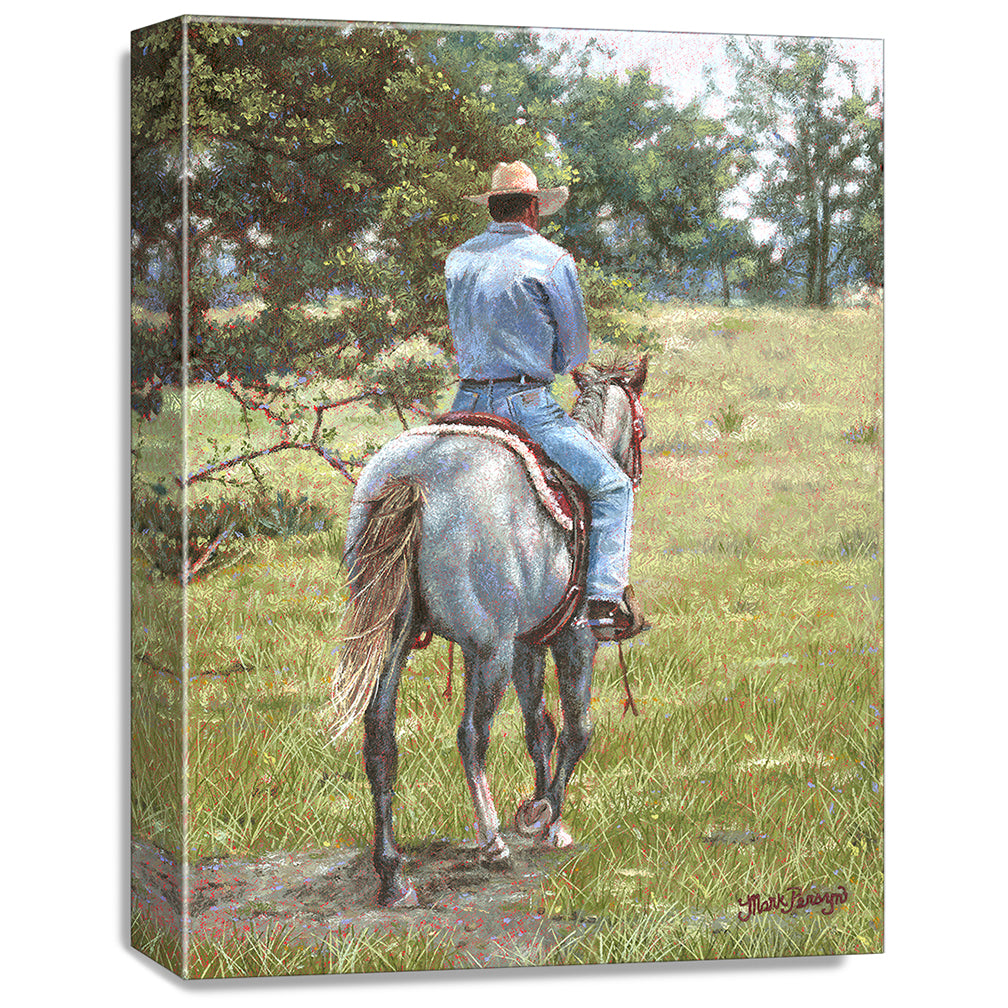 gallery wrapped print on canvas
depicting a cowboy riding
away on a grey horse 