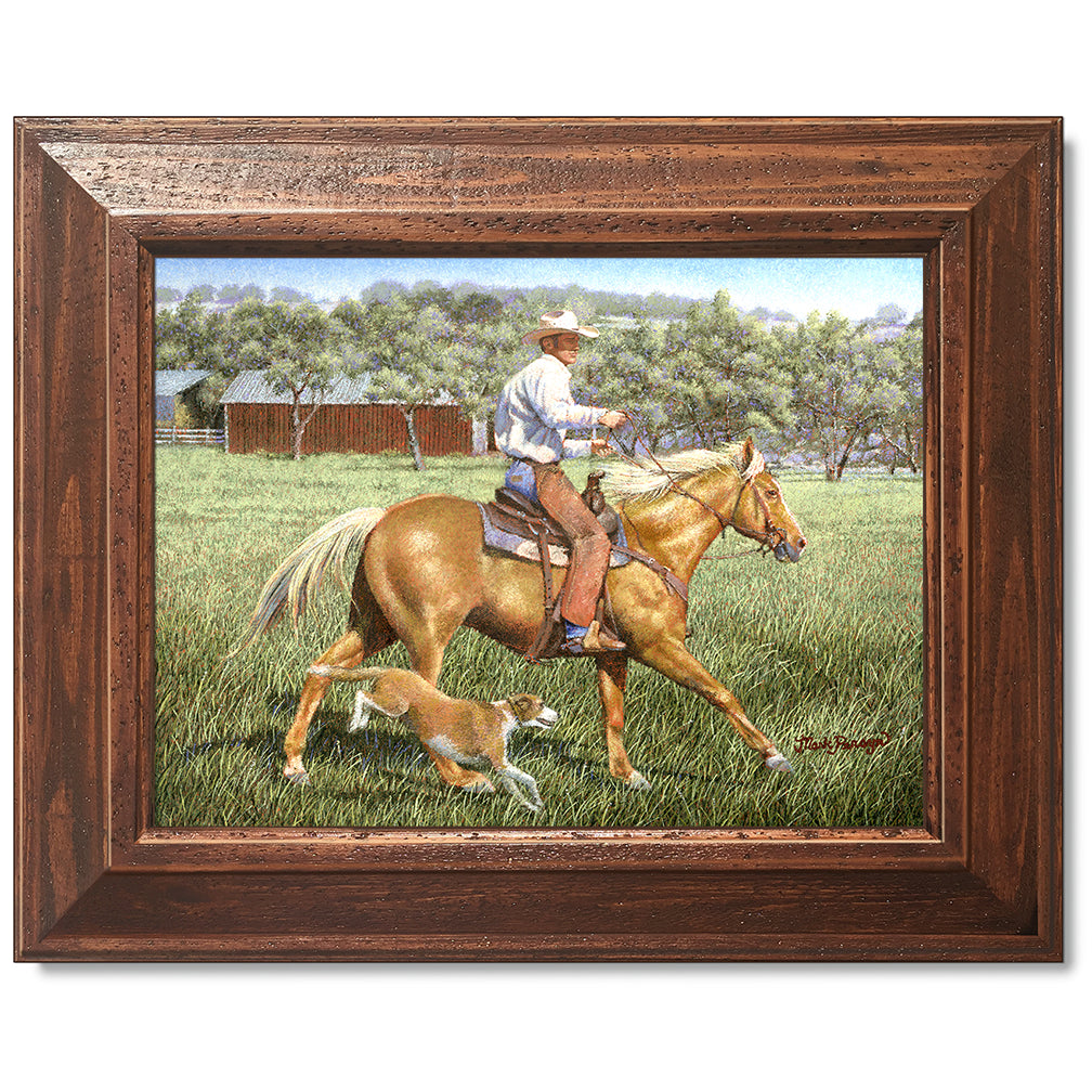 canvas print in a brown wood frame depicting a cowboy on
horseback with his dog alongside