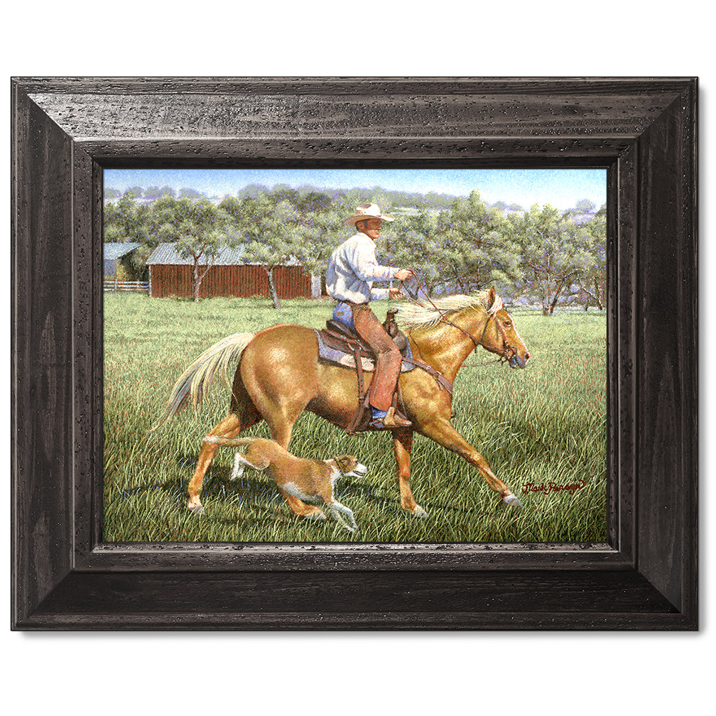 canvas print in a black wood frame depicting a cowboy on
horseback with his dog alongside