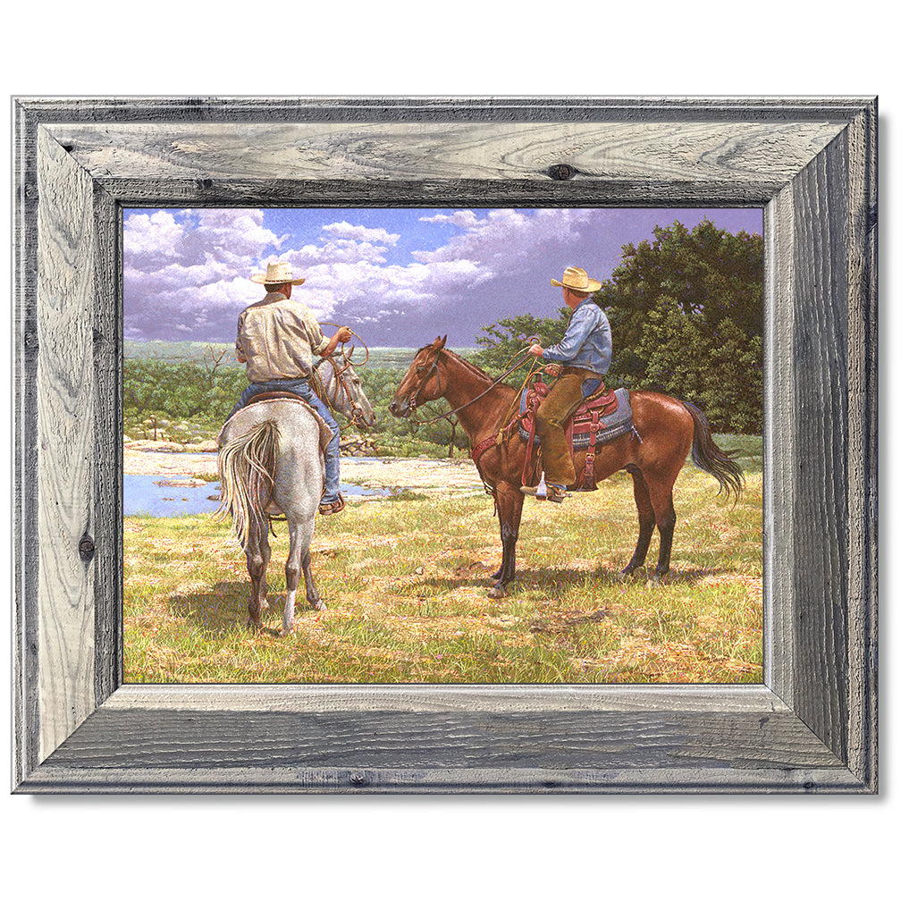 canvas print in a grey wood frame depicting a country landscape
with two cowboys on horseback watching a thunderstorm