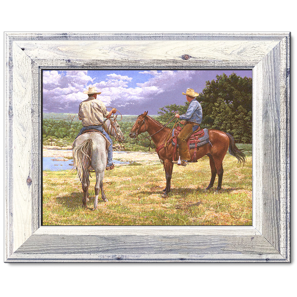 canvas print in a white wood frame depicting a country landscape
with two cowboys on horseback watching a thunderstorm