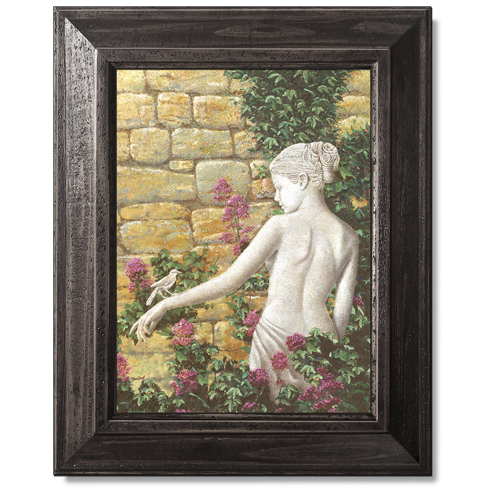 canvas print in a black wood frame depicting a statue of a woman
with a bird on her arm in front of a rock wall with flowers