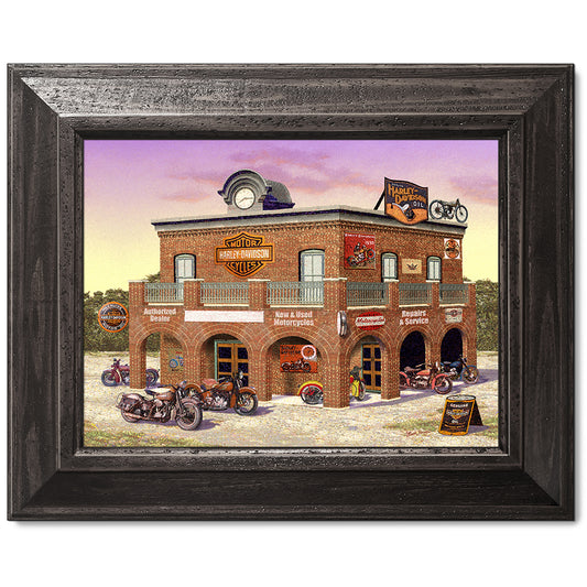 canvas print in a brown wood frame depicting classic motorcycles
parked in front of a vintage harley-davidson dealership