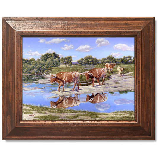 canvas print in a brown wood frame depicting four longhorns
crossing the llano river within a country landscape