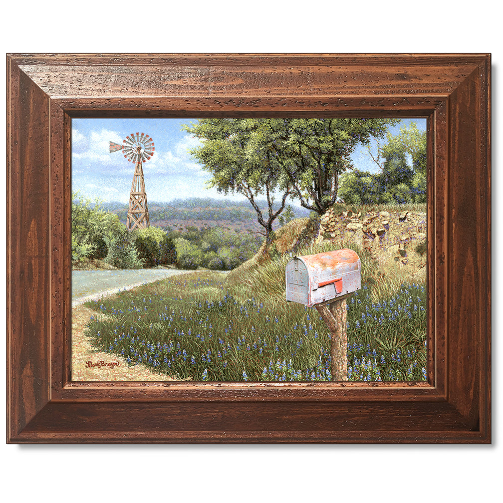 canvas print in a brown wood frame depicting a mailbox along a
country road with a windmill in the background 