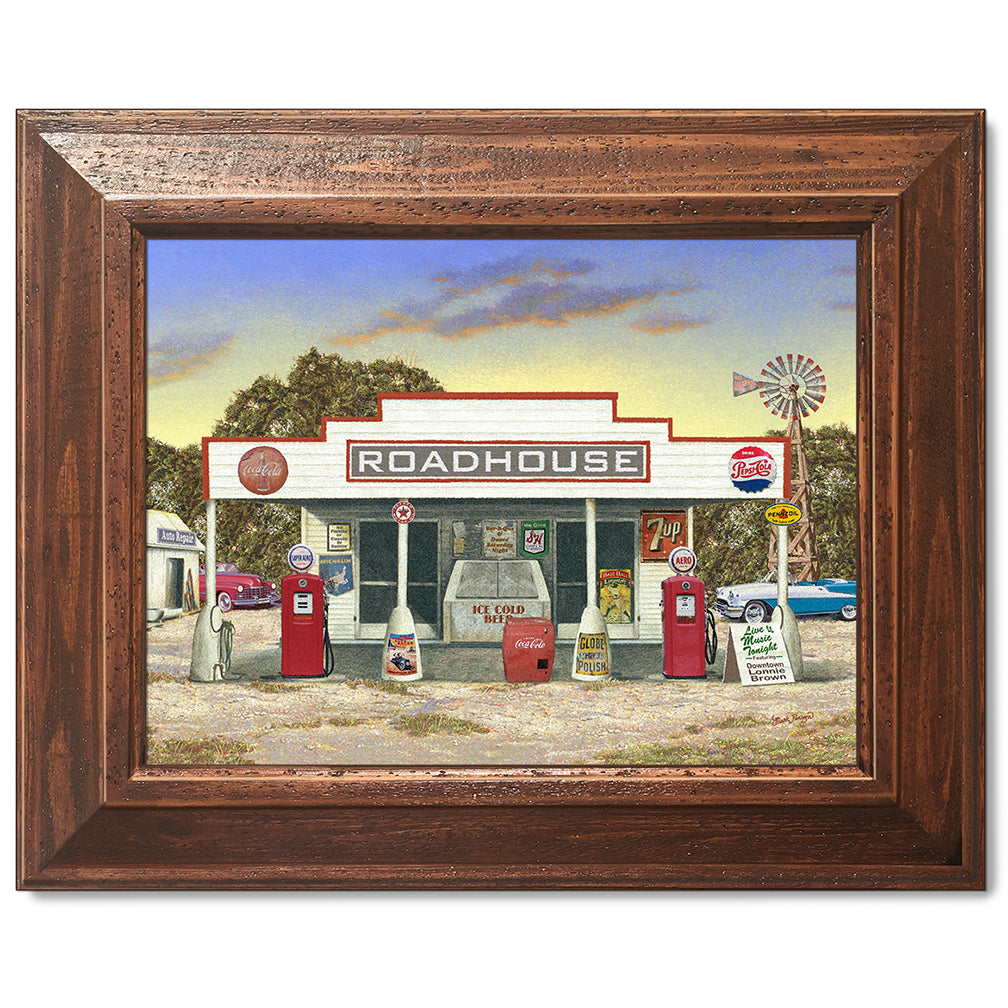 canvas print in a brown wood frame depicting a rustic roadhouse
with classic cars parked nearby